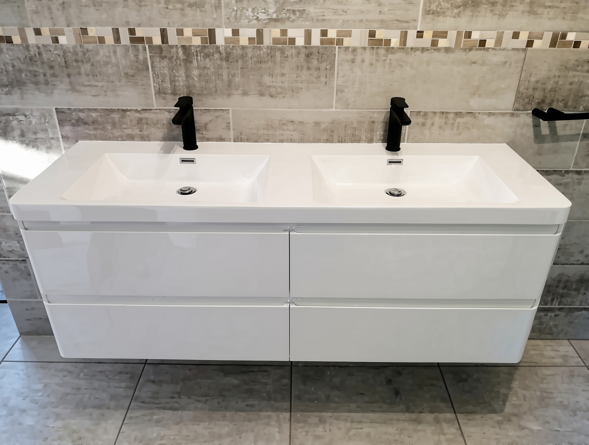 Double white basin vanity with two black taps